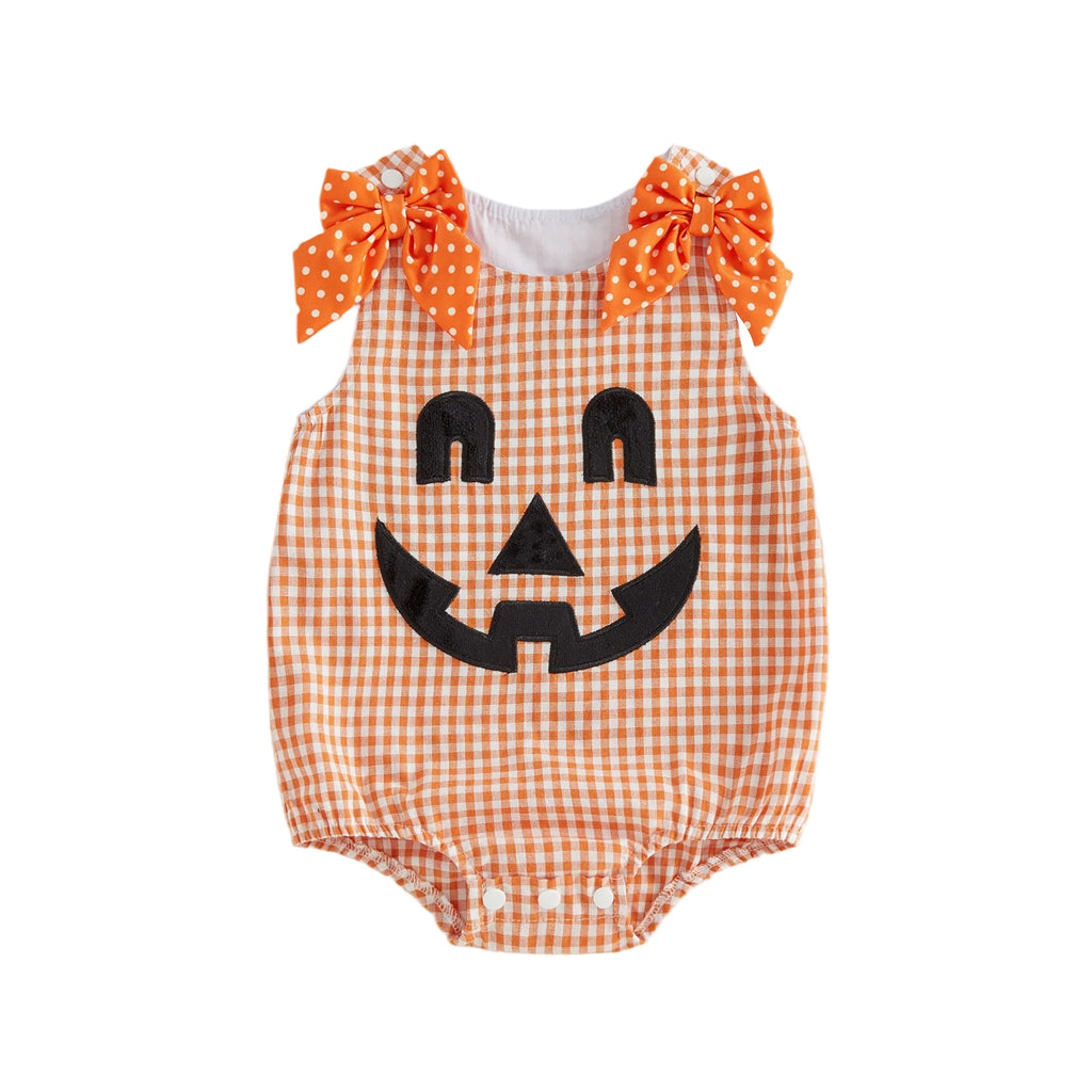 Orange and white plaid baby romper with jack-o'-lantern face and orange polka dot bows on shoulders
