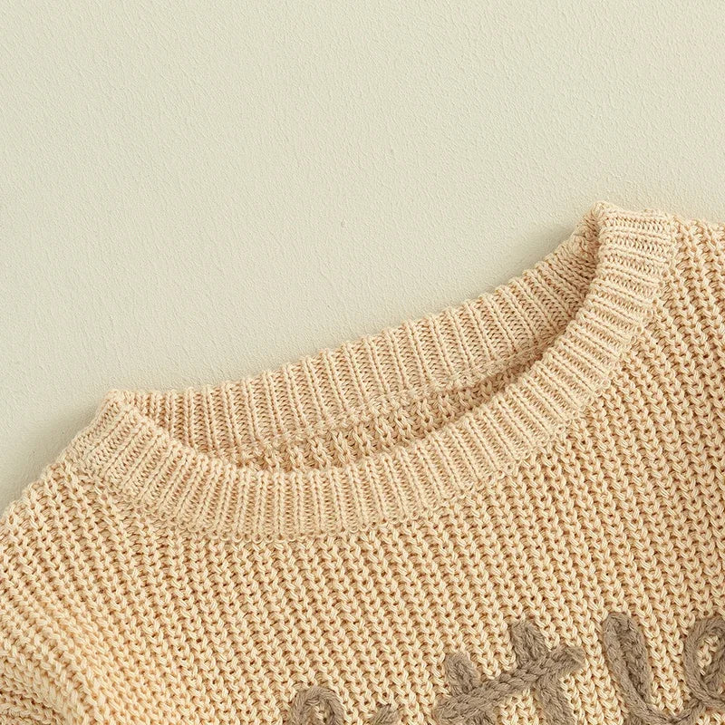 Close view of the embroidered Little Sister lettering