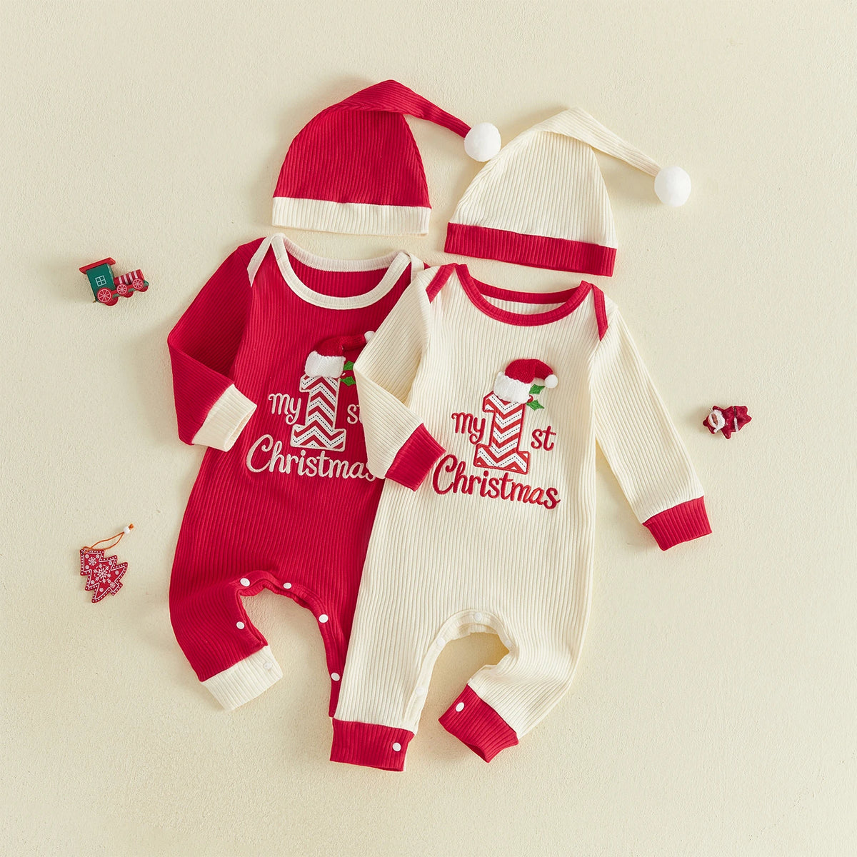 Red and cream ribbed baby rompers with My 1st Christmas embroidery, coordinating pom-pom hats, and contrast cuffs.