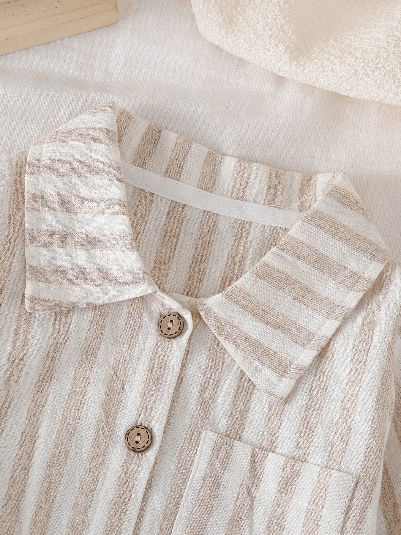 Close-up of Button Collar and Striped Pattern on Bodysuit