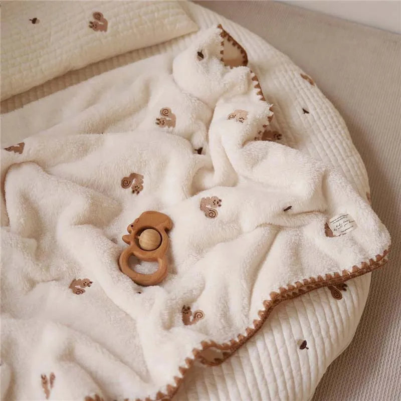 Baby wrapped in Little Friends Blanket
