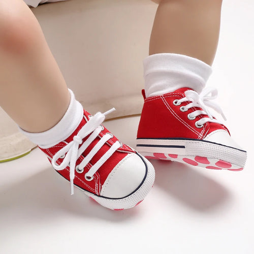 Red Classic Canvas baby sneakers being worn