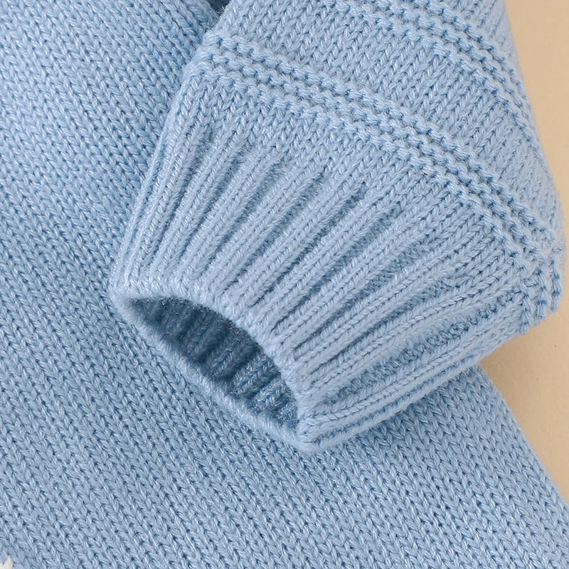 Baby wearing knitted rabbit romper in spring setting