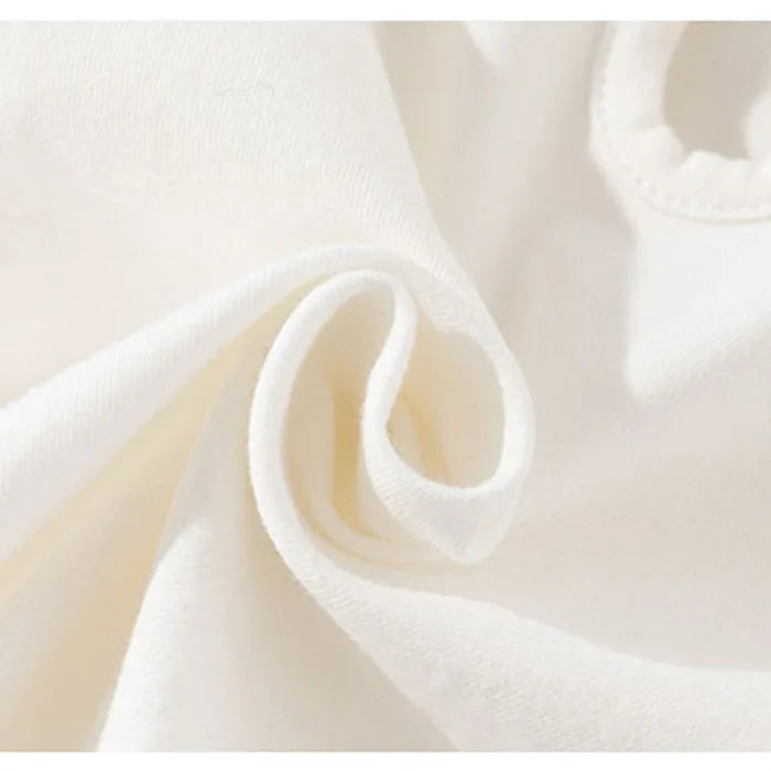 Close view of the white bodysuit fabric and stitching
