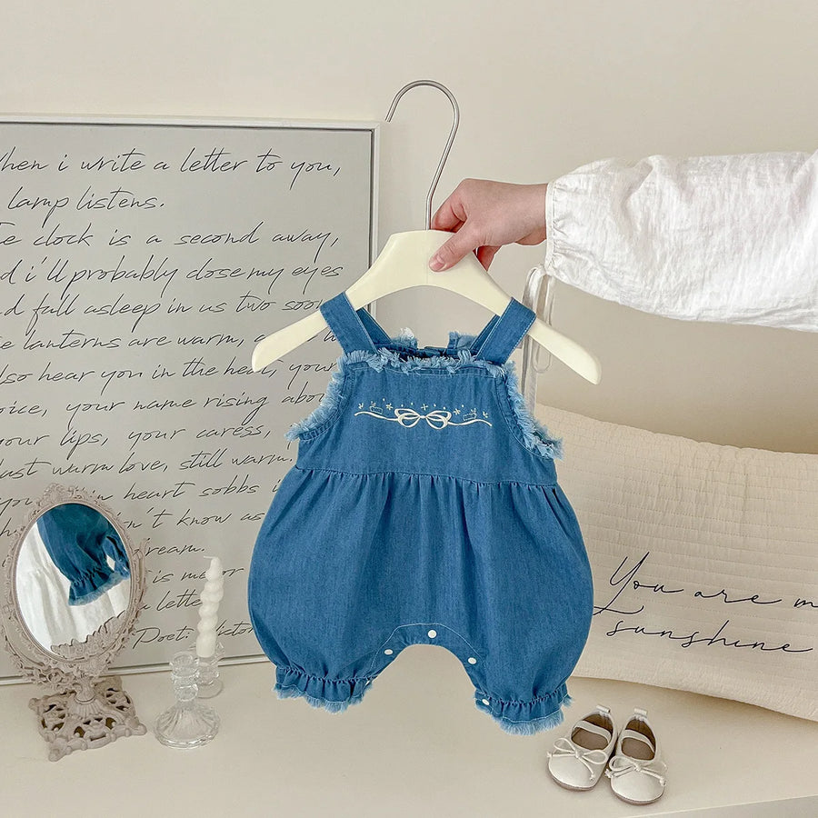 Side view of cotton denim overall romper with bow embroidery for girls