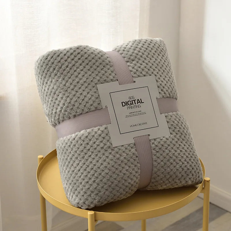 Soft fleece baby blanket on nursery crib