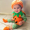 Baby wearing an orange pumpkin romper costume set with green leaf collar, matching pumpkin hat, and orange booties