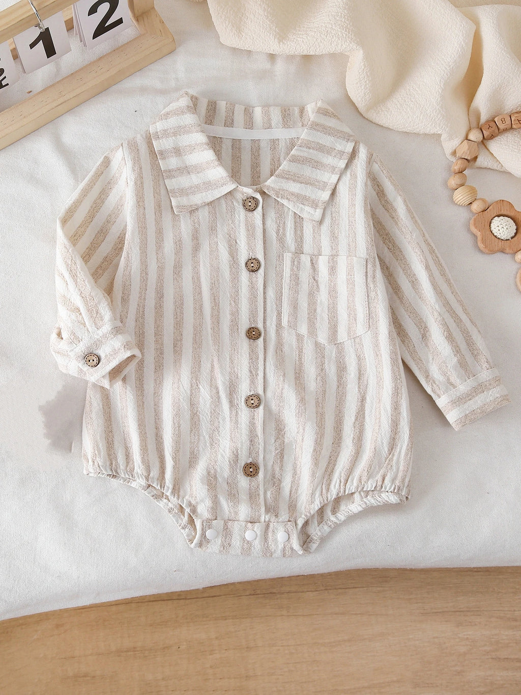 Detail of Crotch Snaps on Striped Long-Sleeve Bodysuit