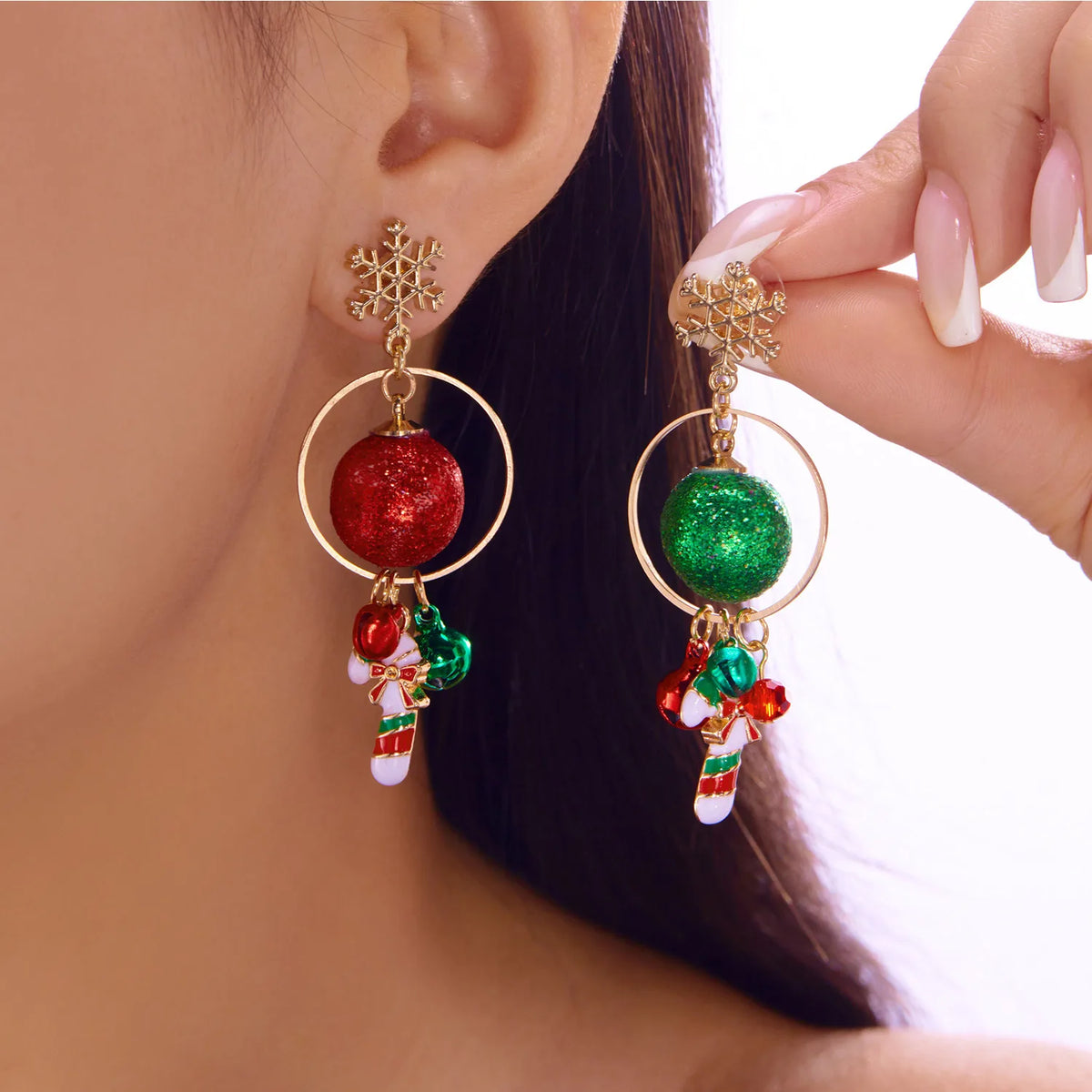 Snowflake tops, circular hoops, glittering red and green baubles, and candy cane charms.