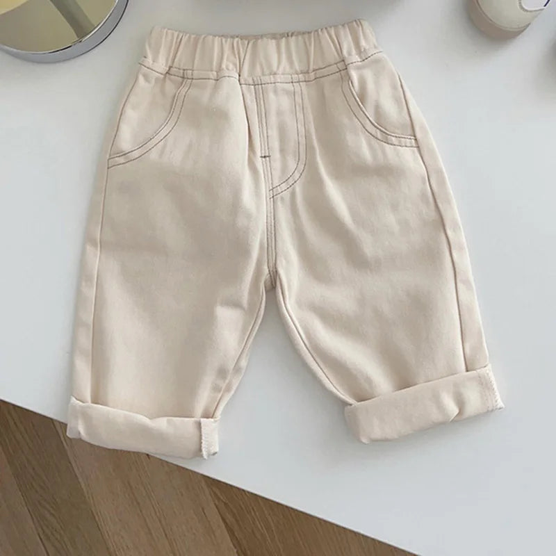 Beige cuffed denim pants with elastic waist and front pockets