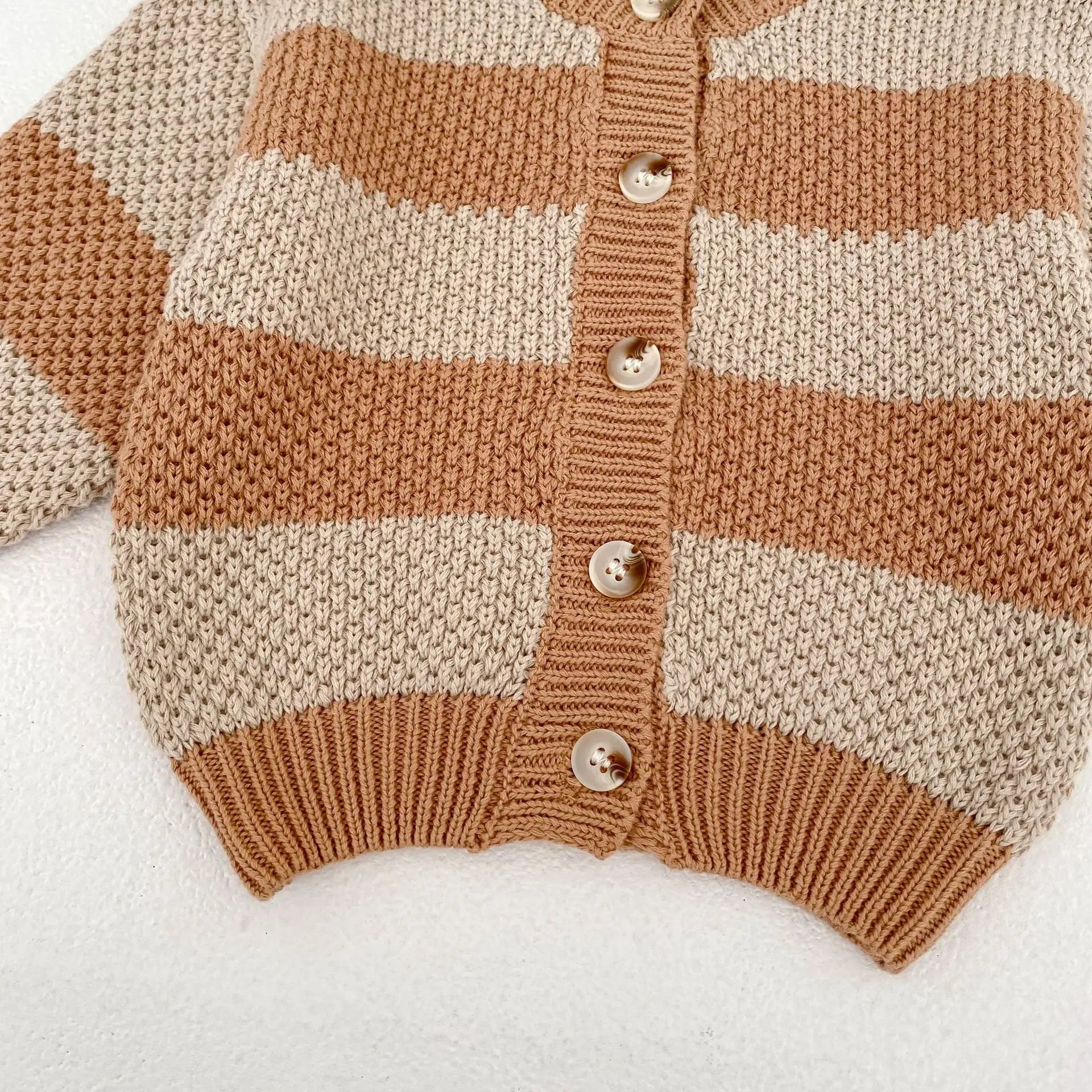 Baby wearing striped knitted cardigan sweater jacket in khaki color