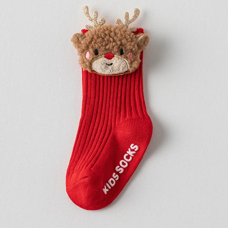 Red ribbed baby sock with a textured brown reindeer face, red nose, and gold-colored antlers.