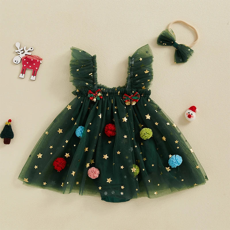 Green star-print baby romper dress with ruffled straps and colorful pom-poms, shown with a coordinating bow headband.