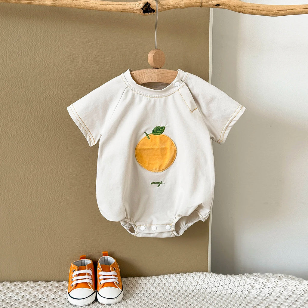 Apricot Fruit Patch Bubble Romper displayed on hanger