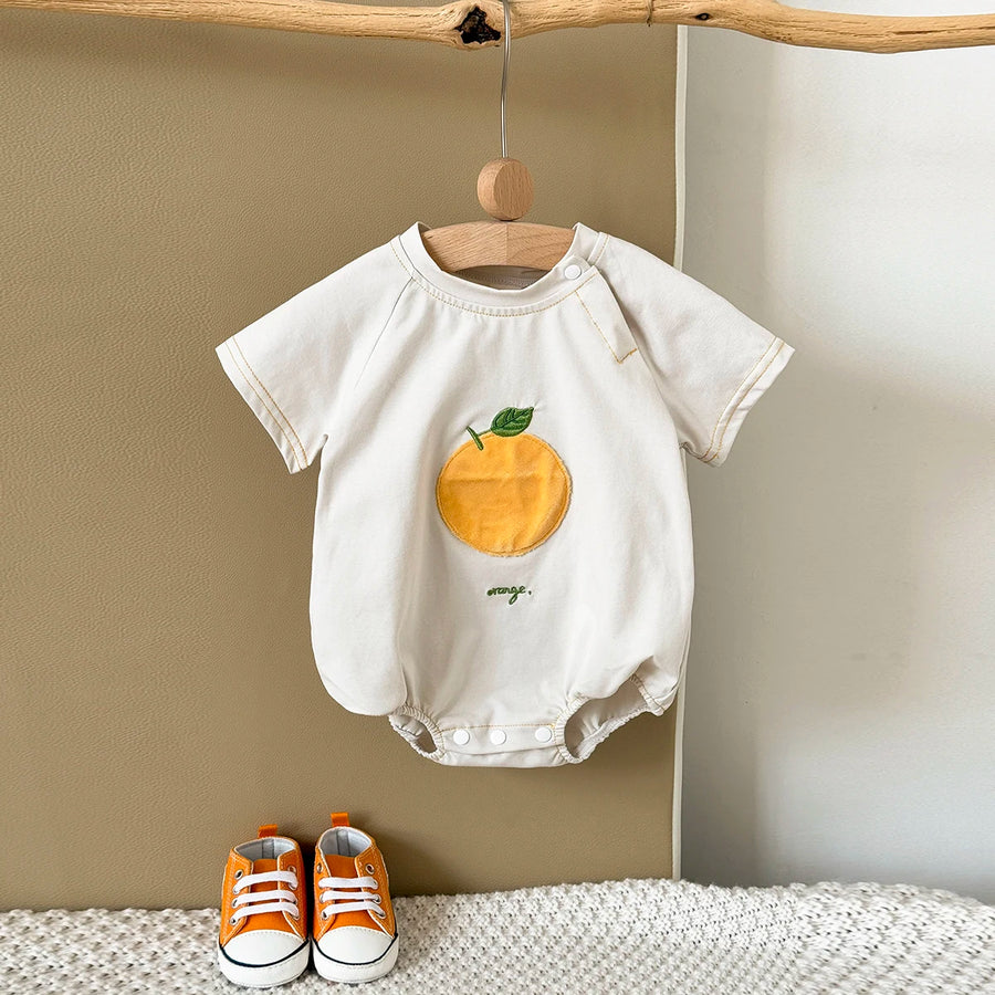 Apricot Fruit Patch Bubble Romper displayed on hanger