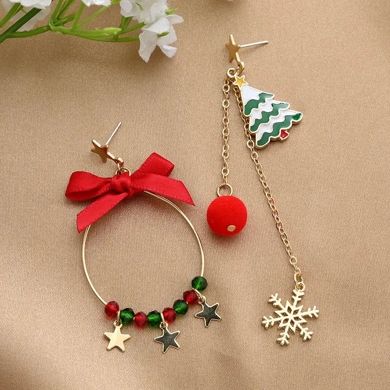 One bow-trimmed hoop with star charms pairs with a tree-and-snowflake chain earring.