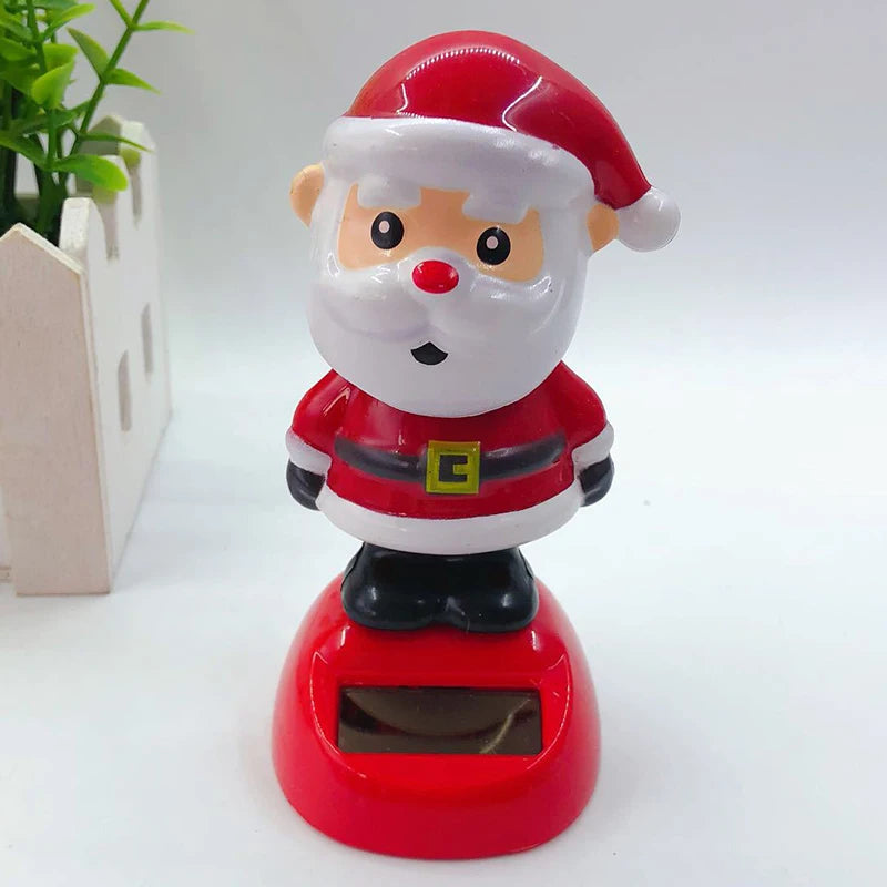 Close-up of Santa Christmas solar bobblehead with a white beard, black belt and red base