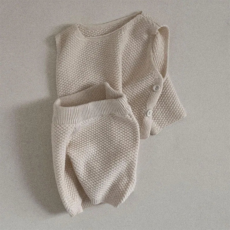 Front view of baby sleeveless knit vest and shorts set in yellow