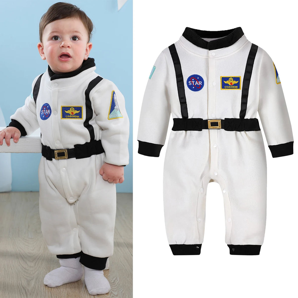 Toddler wearing white astronaut romper costume in space-themed room