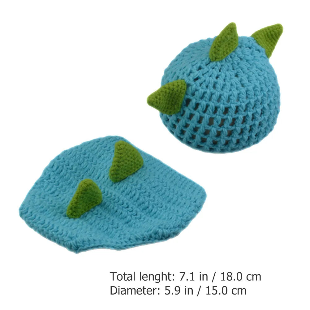 Knitted blue dinosaur hat and diaper cover with green spikes, shown with size measurements