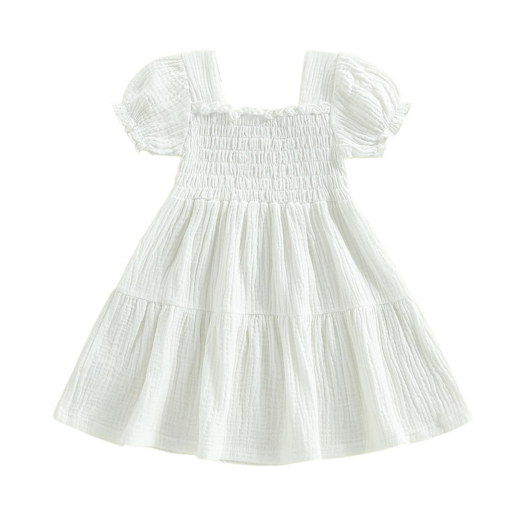 White smocked puff-sleeve dress on white background