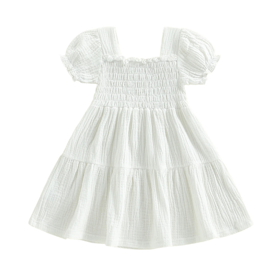 White smocked puff-sleeve dress on white background