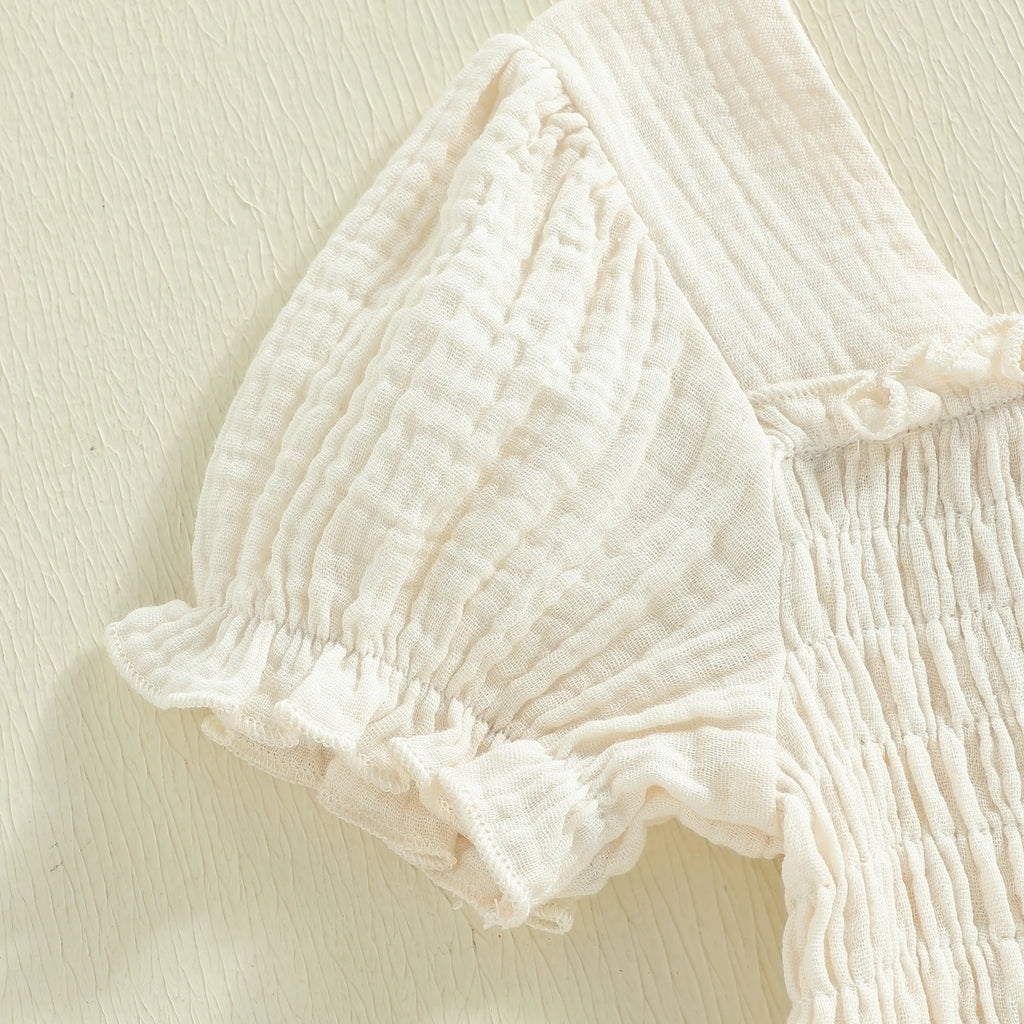 Short puff-sleeve detail on ivory smocked dress