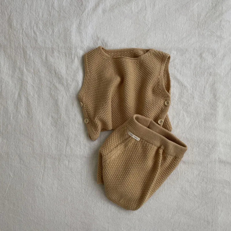 Baby knit vest and shorts set displayed on a flat surface