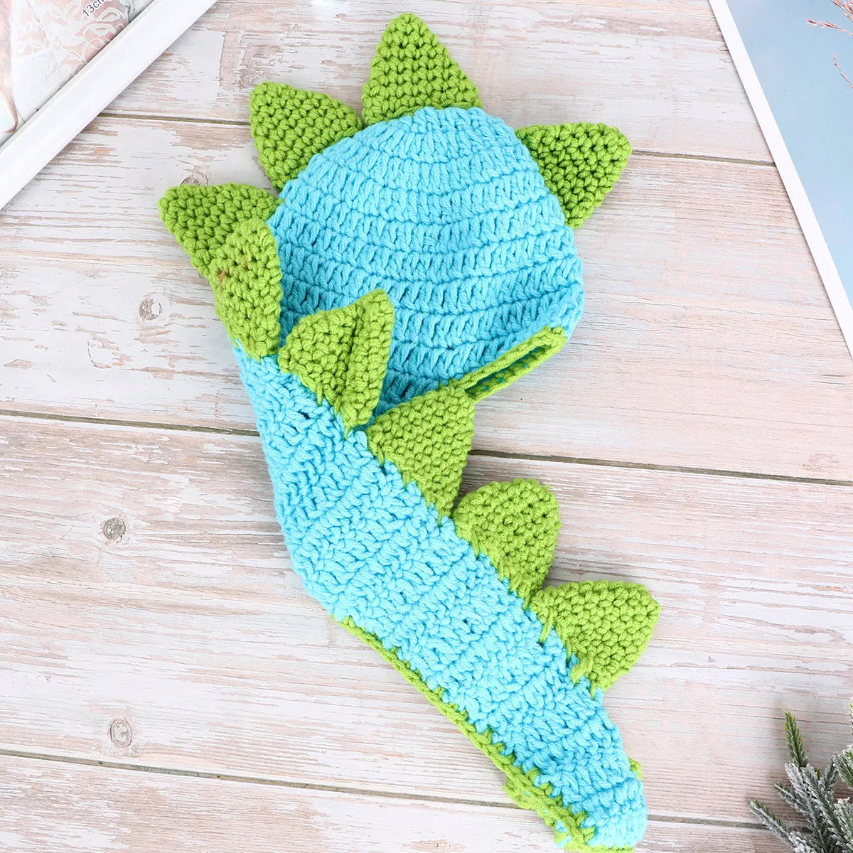 Blue crochet dinosaur hat with green spikes and matching tail