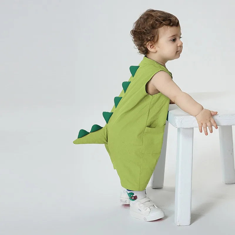 Baby wearing light green dinosaur tail romper costume