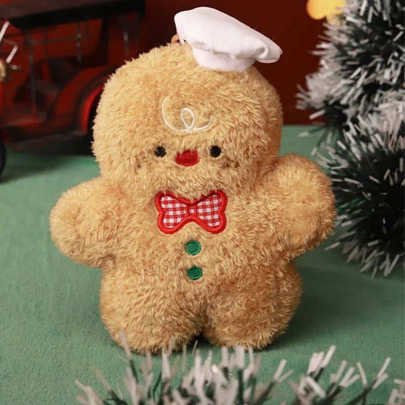 Gingerbread baker Christmas plush figure with a white chef hat, a red checked bow, and green stitched buttons