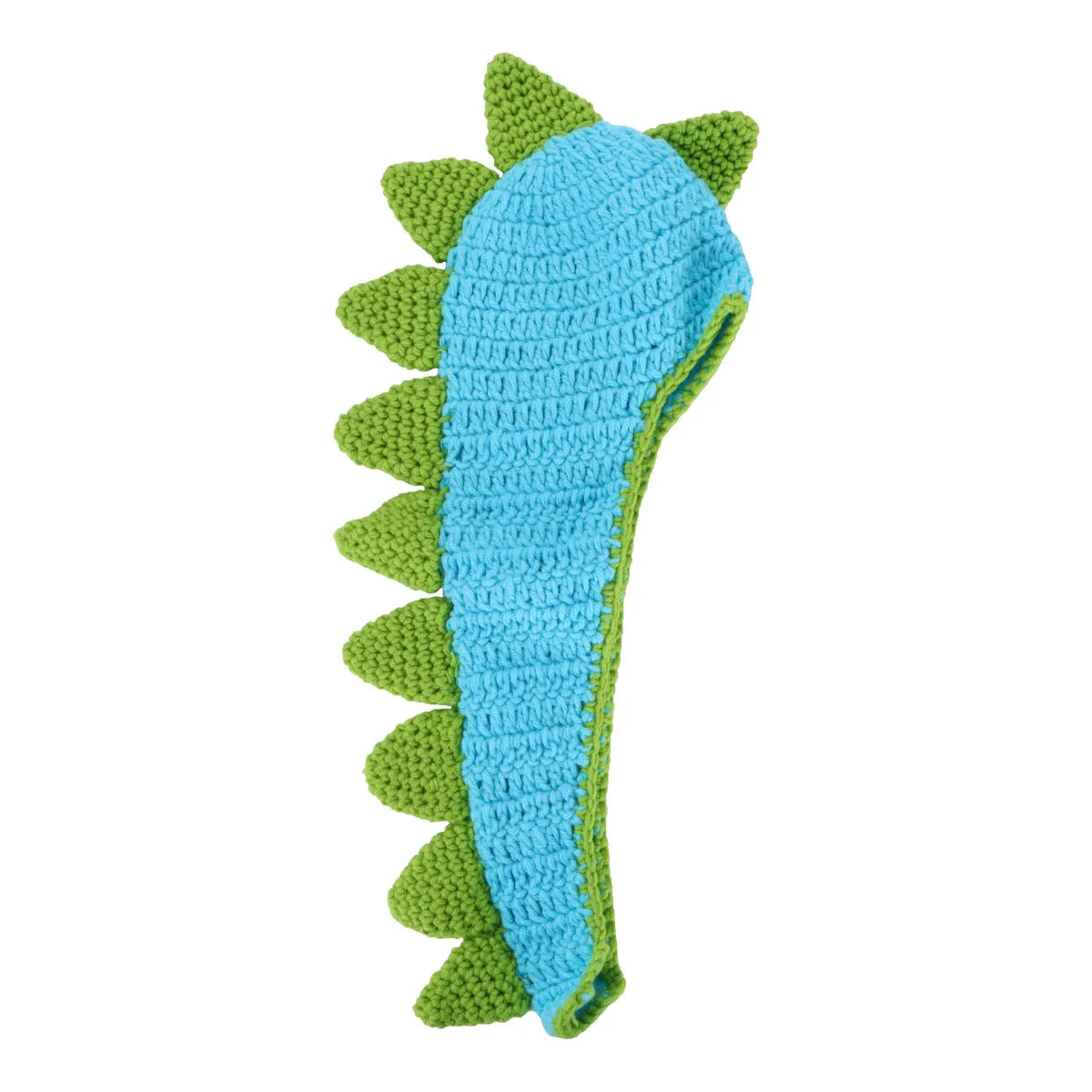 Blue crochet dinosaur tail with green spikes on wooden surface