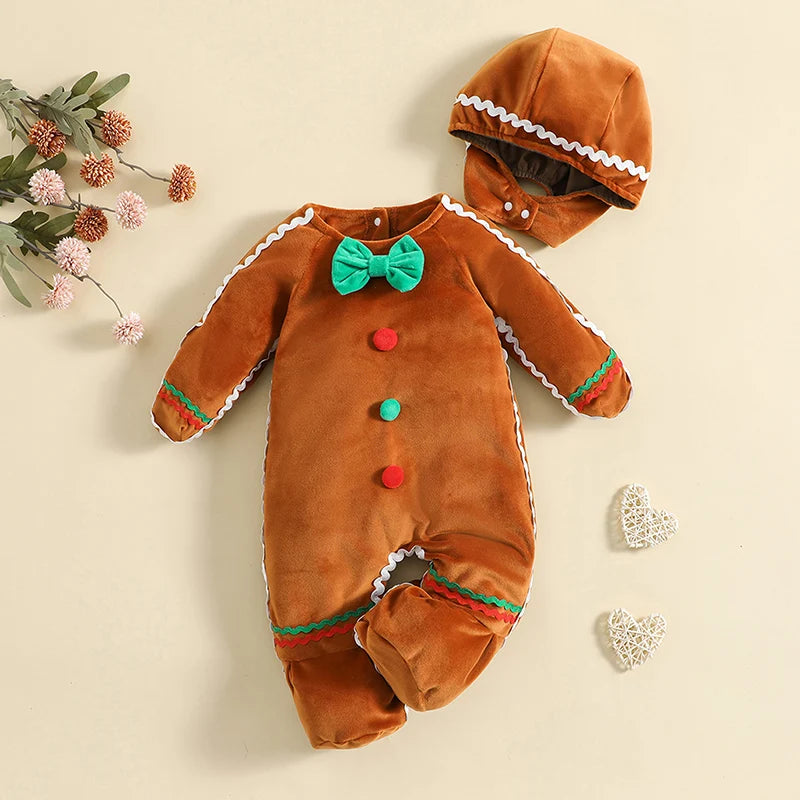 Brown gingerbread-style footed baby costume and matching hat with a green bow tie, colored buttons, and white wavy trim.