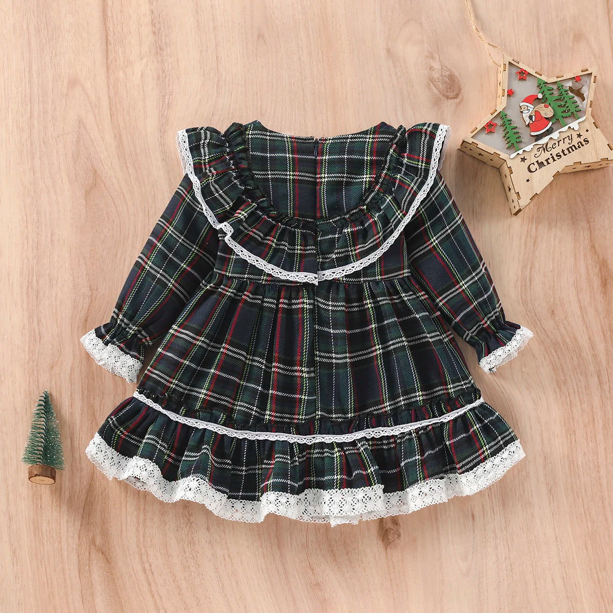 Dark green tartan long-sleeve dress with a ruffled collar, tiered hem, and white lace trim.