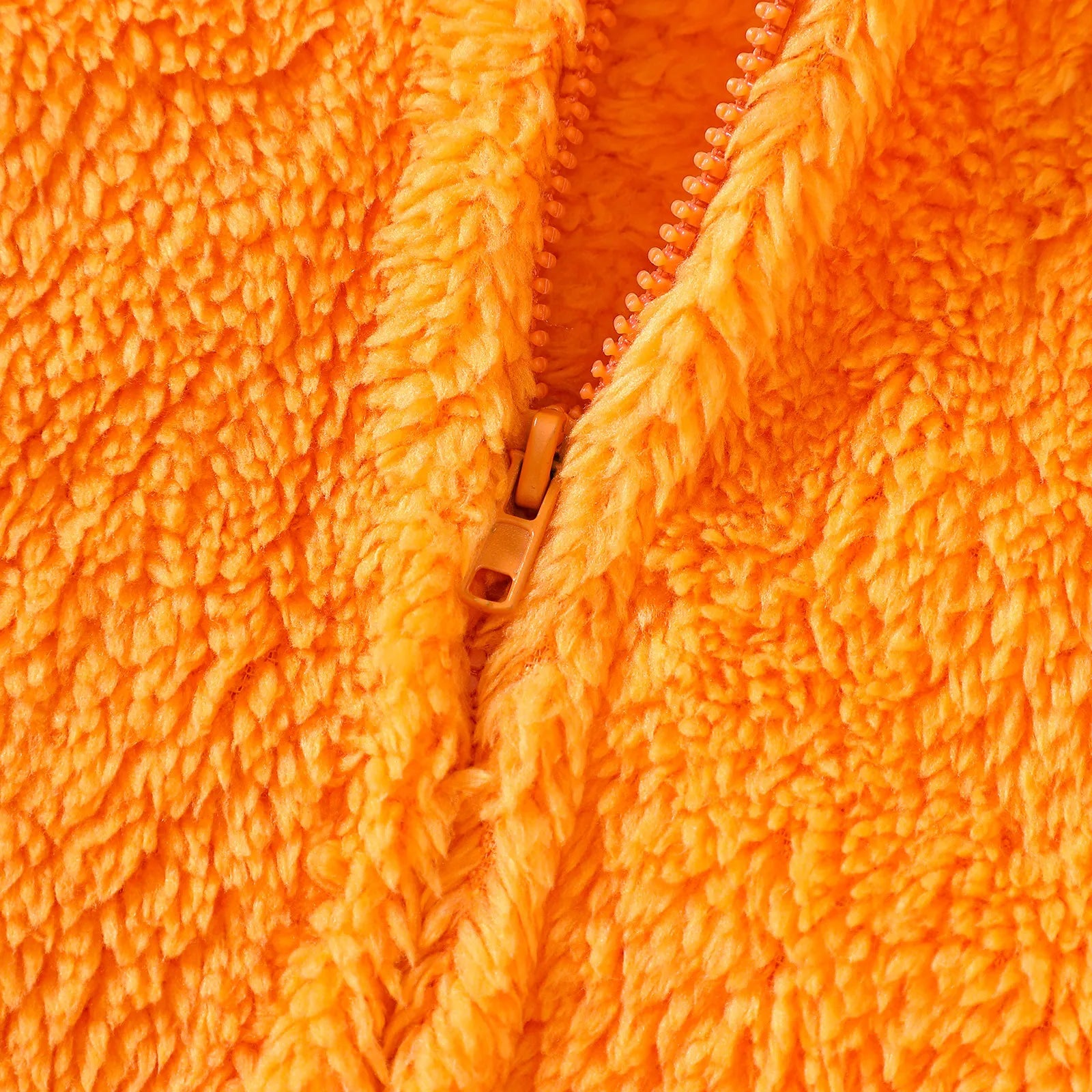 Close-up of front zipper on orange fleece cloak costume