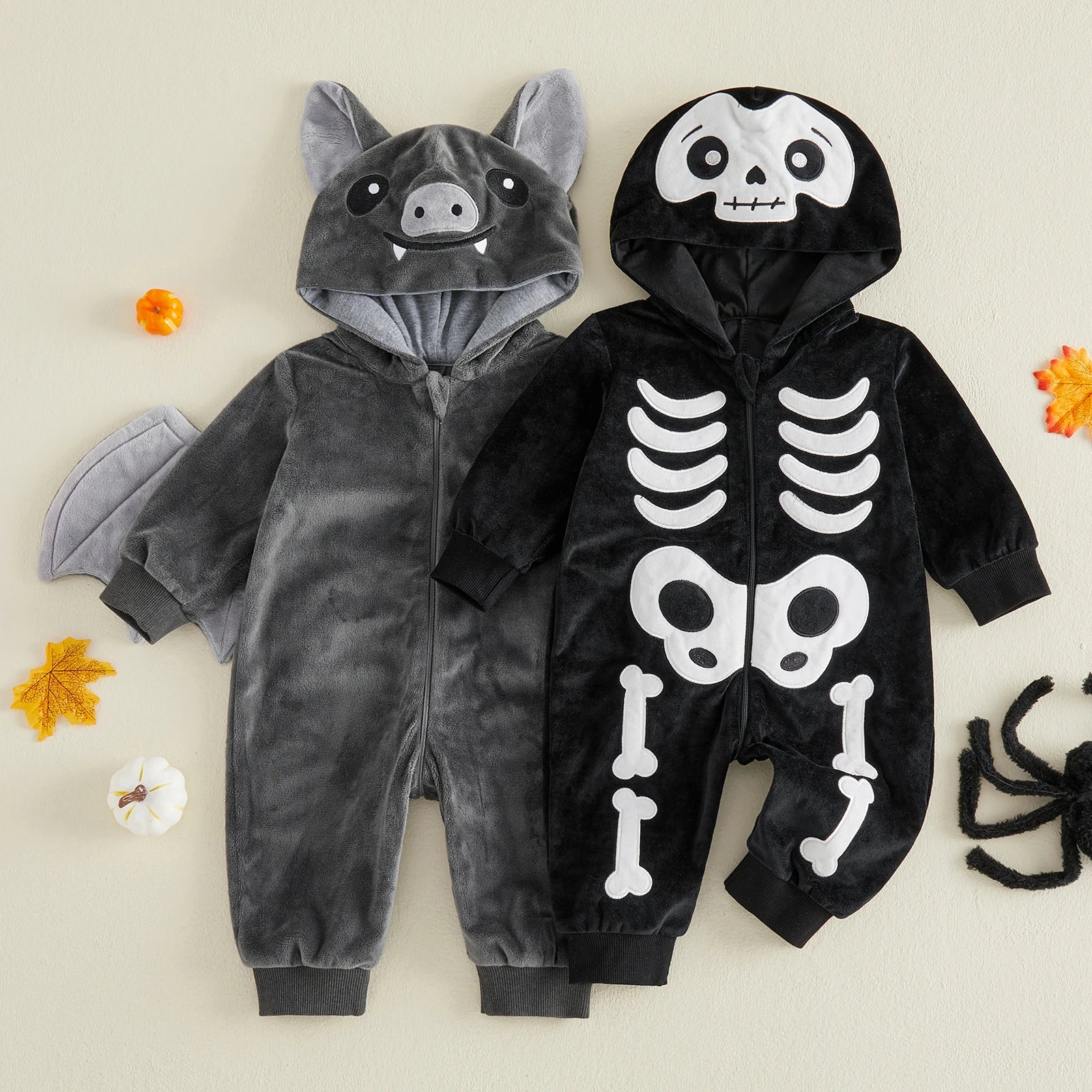 Black skeleton and gray bat hooded rompers side by side