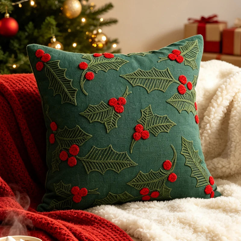 Christmas pillow cover featuring green holly leaves and red berries on a green background.
