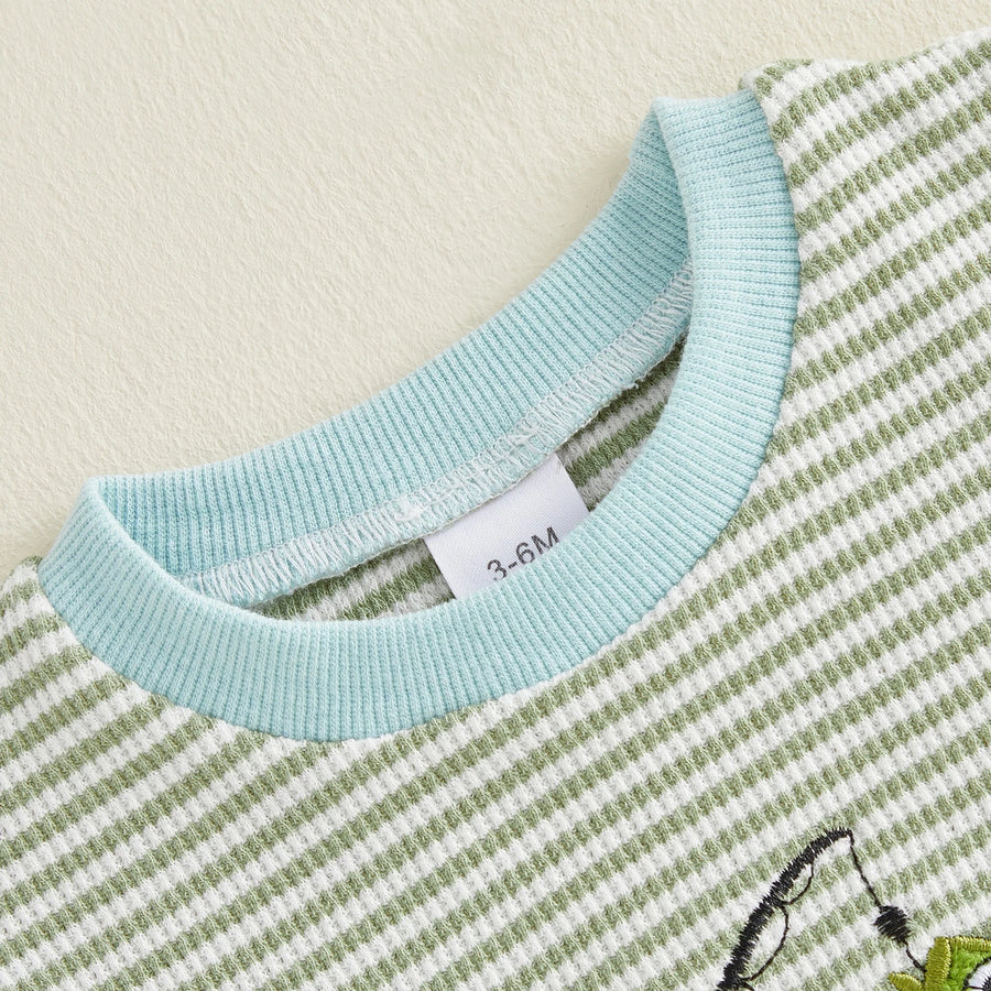 Close-up of fish embroidery detail on baby romper