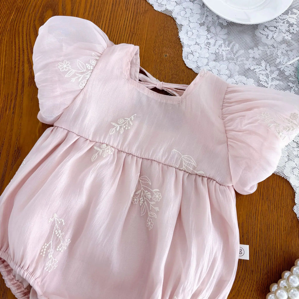 Side view of pink short sleeve baby romper