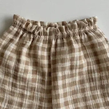 Plaid baby pants on a gray background