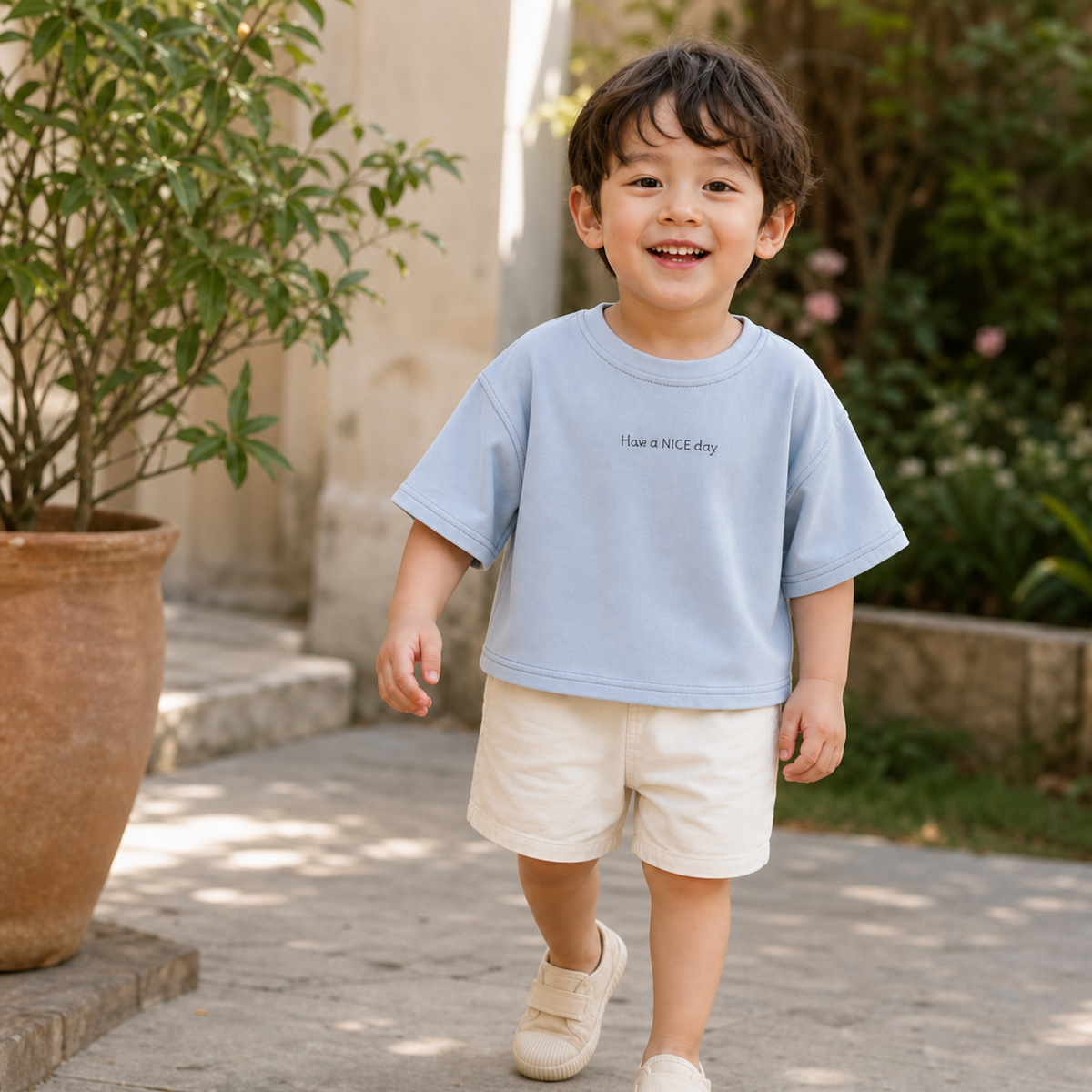 Three-year-old wearing the Blue Have a Nice Day Short Sleeve Tee outdoors