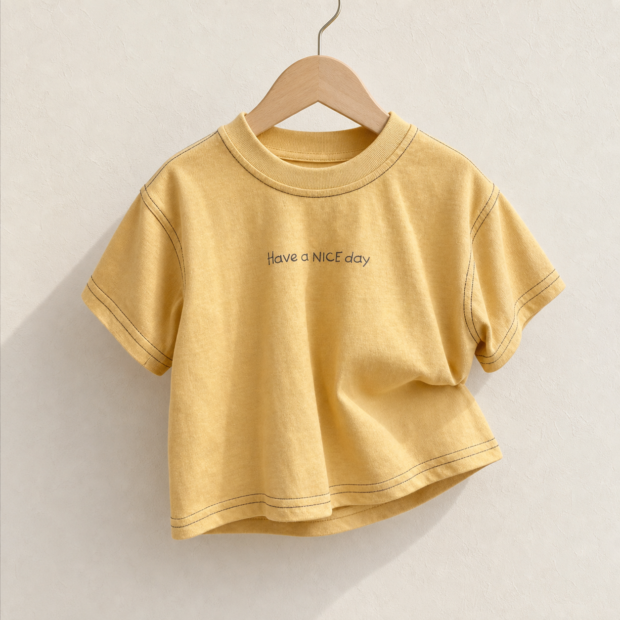 Yellow Have a Nice Day Short Sleeve Tee on a wood hanger