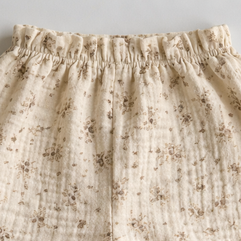 Floral-patterned baby pants on a light gray background