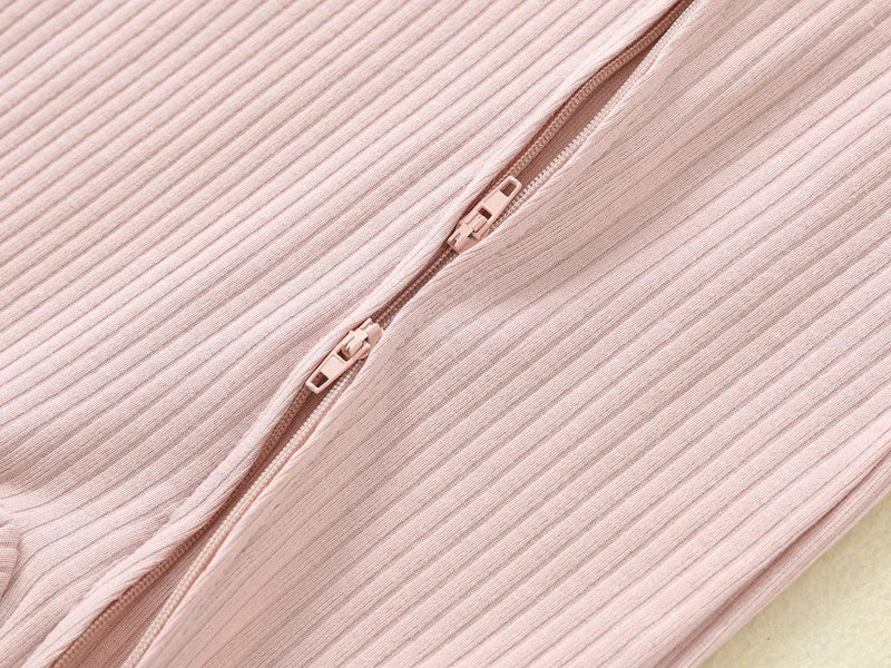Close-up of the two-way zipper on the Blush Pink ribbed romper, with both pulls visible.